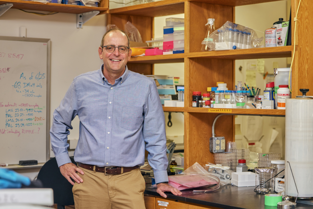 Dr. Ben Van Mooy standing in his lab, surrounded by equipment.